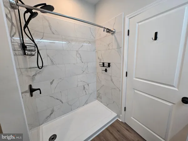 a bathroom with a tub and a shower