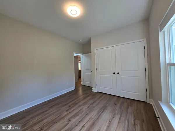 a view of an empty room and wooden floor