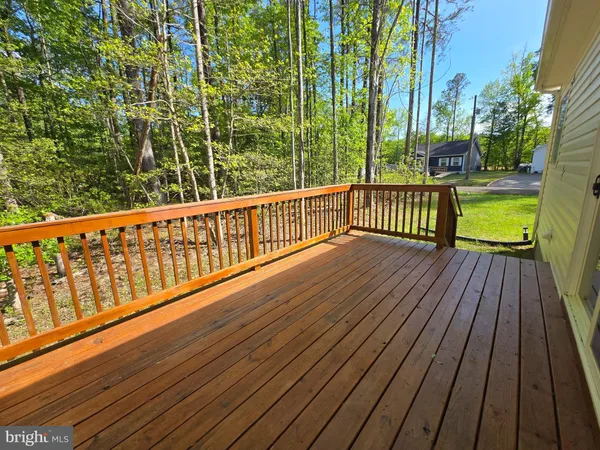 a view of balcony with wooden floor and fence