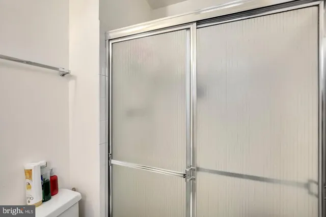 a bathroom with a glass shower door