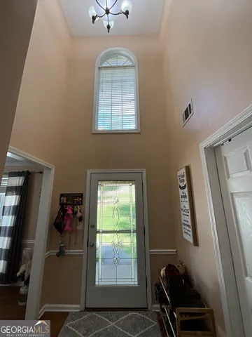 a kitchen with granite countertop a sink a stove a refrigerator and cabinets