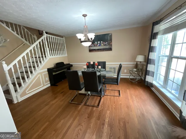 a view of a dining room with furniture window and wooden floor
