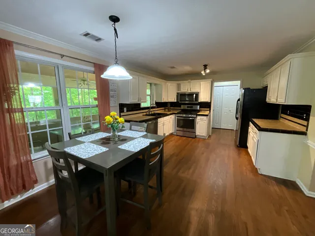 a living room with fireplace furniture and a large window