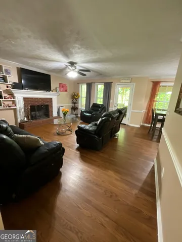 a large white kitchen with a sink a large window and a stove