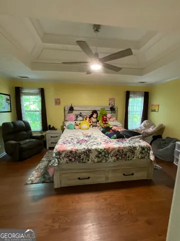 a bed room with a bed and a ceiling fan