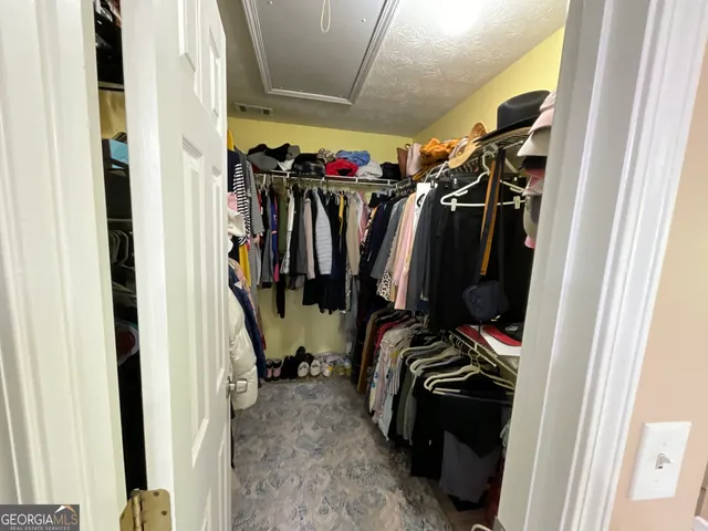 a kitchen with a refrigerator and a stove top oven