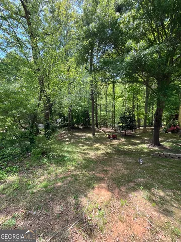 a view of outdoor space with trees all around