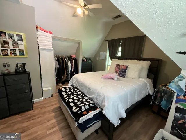 a view of walk in closet with empty racks