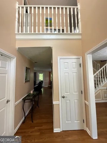 a dining room with furniture a chandelier window and wooden floor