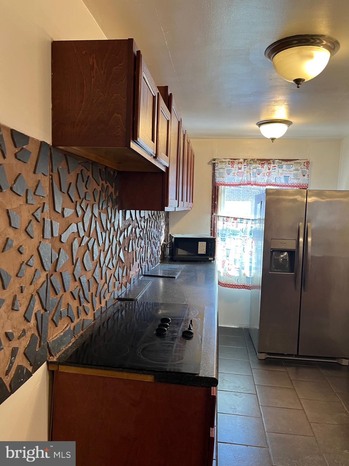 7302 Sherwood Road Philadelphia, PA 19151 - Photo 8 of 51 kitchen matching black and brown back splash