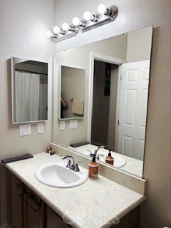 24922 Muirlands Boulevard, Unit 115 Lake Forest, CA 92630 - Photo 11 of 17 a bathroom with a sink vanity and mirror