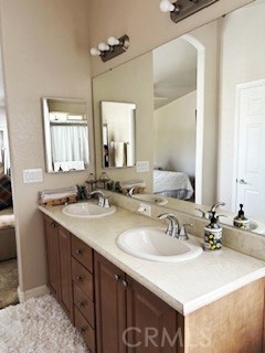24922 Muirlands Boulevard, Unit 115 Lake Forest, CA 92630 - Photo 12 of 17 a bathroom with a sink double vanity and a mirror