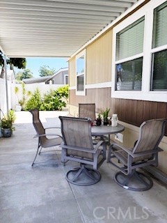24922 Muirlands Boulevard, Unit 115 Lake Forest, CA 92630 - Photo 16 of 17 a view of a patio with couple of chairs and a potted plant