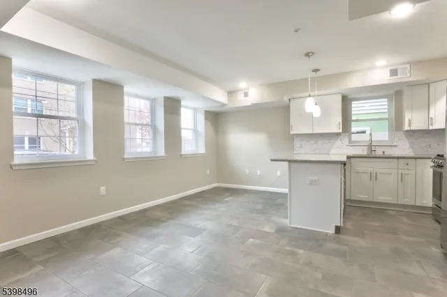 a view of a kitchen with a sink cabinets and wooden floor
