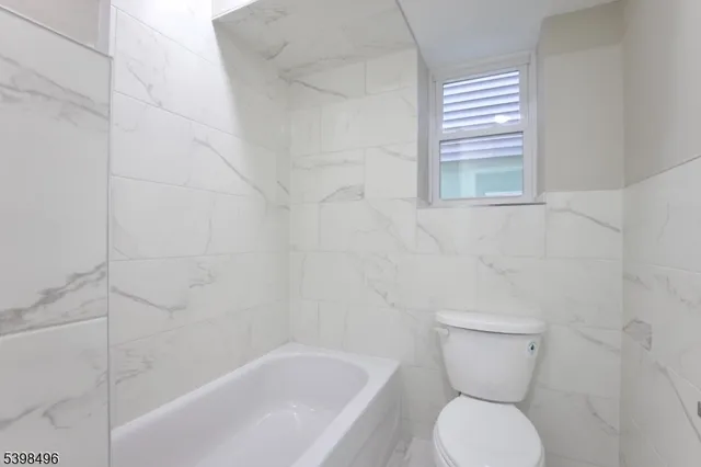 a bathroom with a toilet and a bathtub