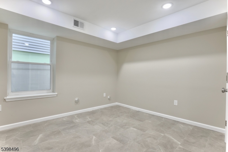 32 Garibaldi Avenue, Unit 1 Newark, NJ 07114 - Photo 8 of 12 an empty room with a window