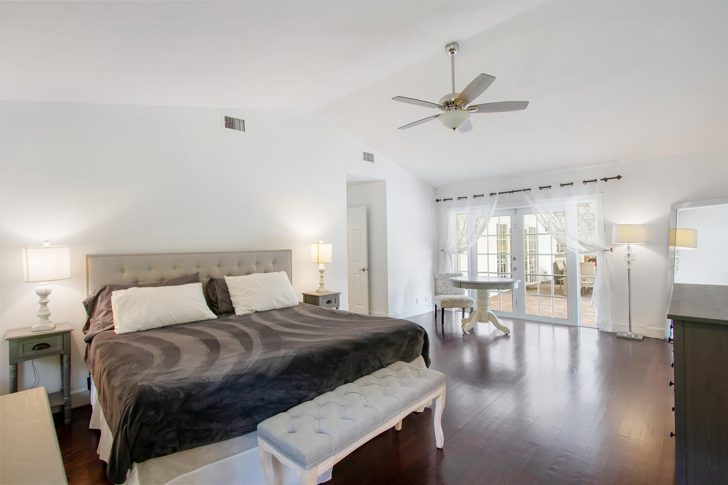 12327 Quercus Lane Wellington, FL 33414 - Photo 11 of 34 a bedroom with a bed a table and chairs with wooden floor