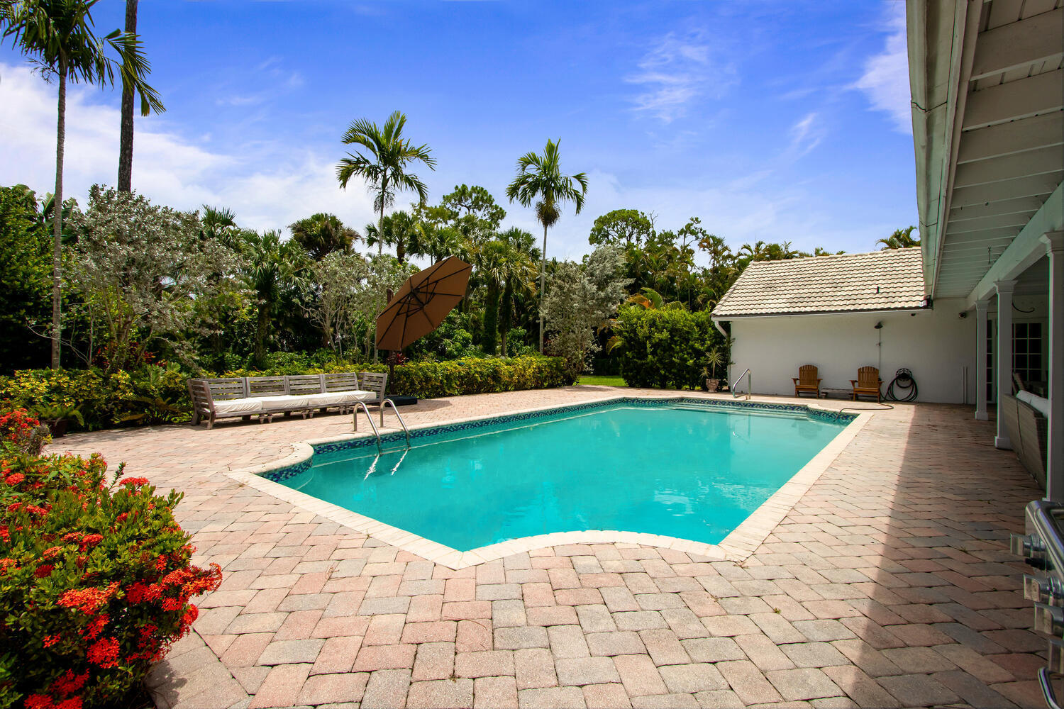 12327 Quercus Lane Wellington, FL 33414 - Photo 23 of 34 a view of a swimming pool with an outdoor space and seating area