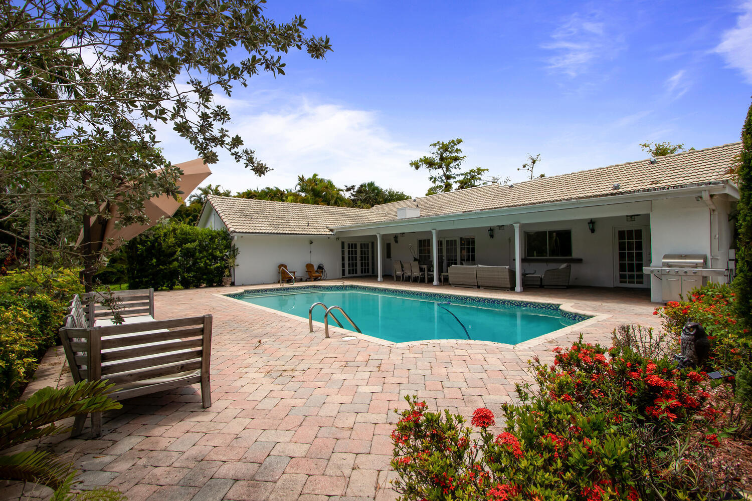 12327 Quercus Lane Wellington, FL 33414 - Photo 24 of 34 a front view of a house with a garden and yard