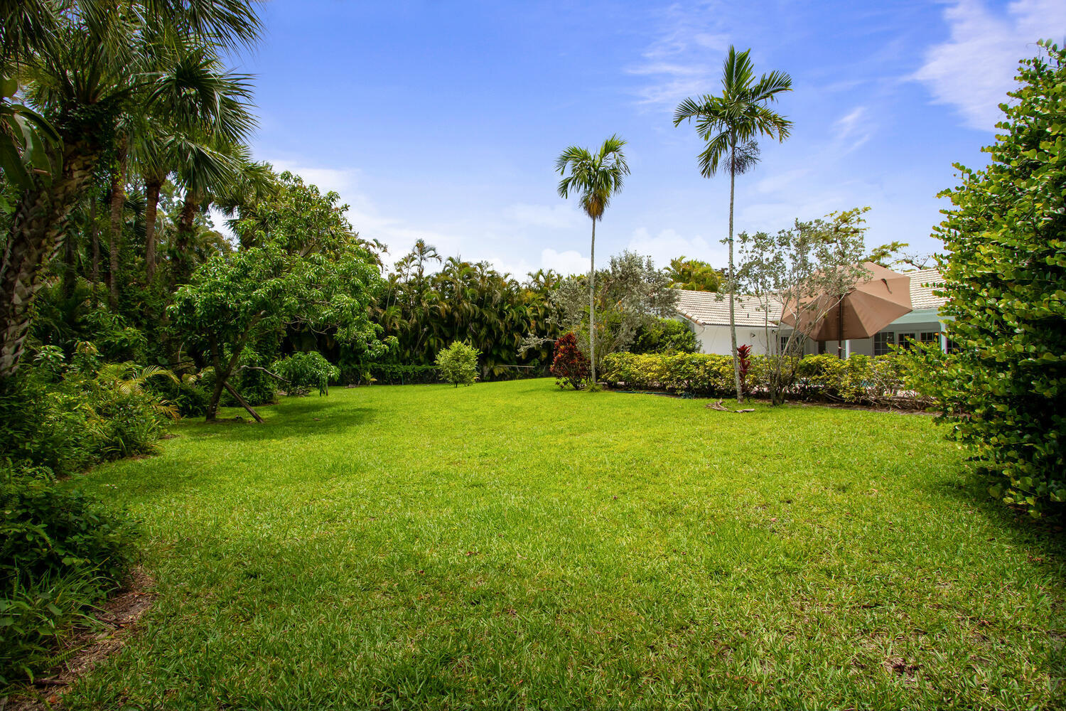 12327 Quercus Lane Wellington, FL 33414 - Photo 28 of 34 a view of a garden with a tree