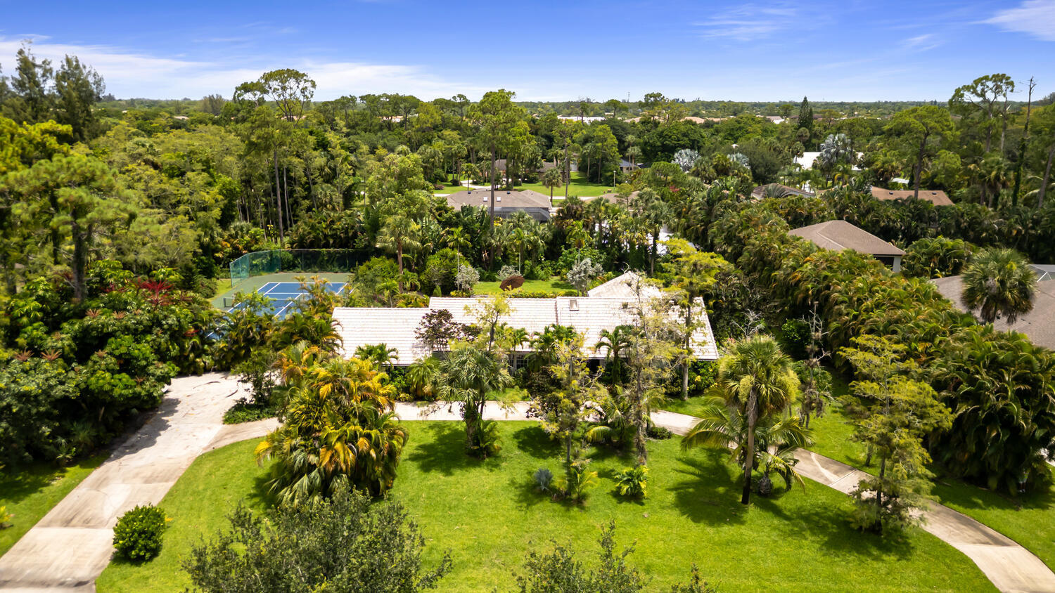 12327 Quercus Lane Wellington, FL 33414 - Photo 31 of 34 a view of a lake with houses
