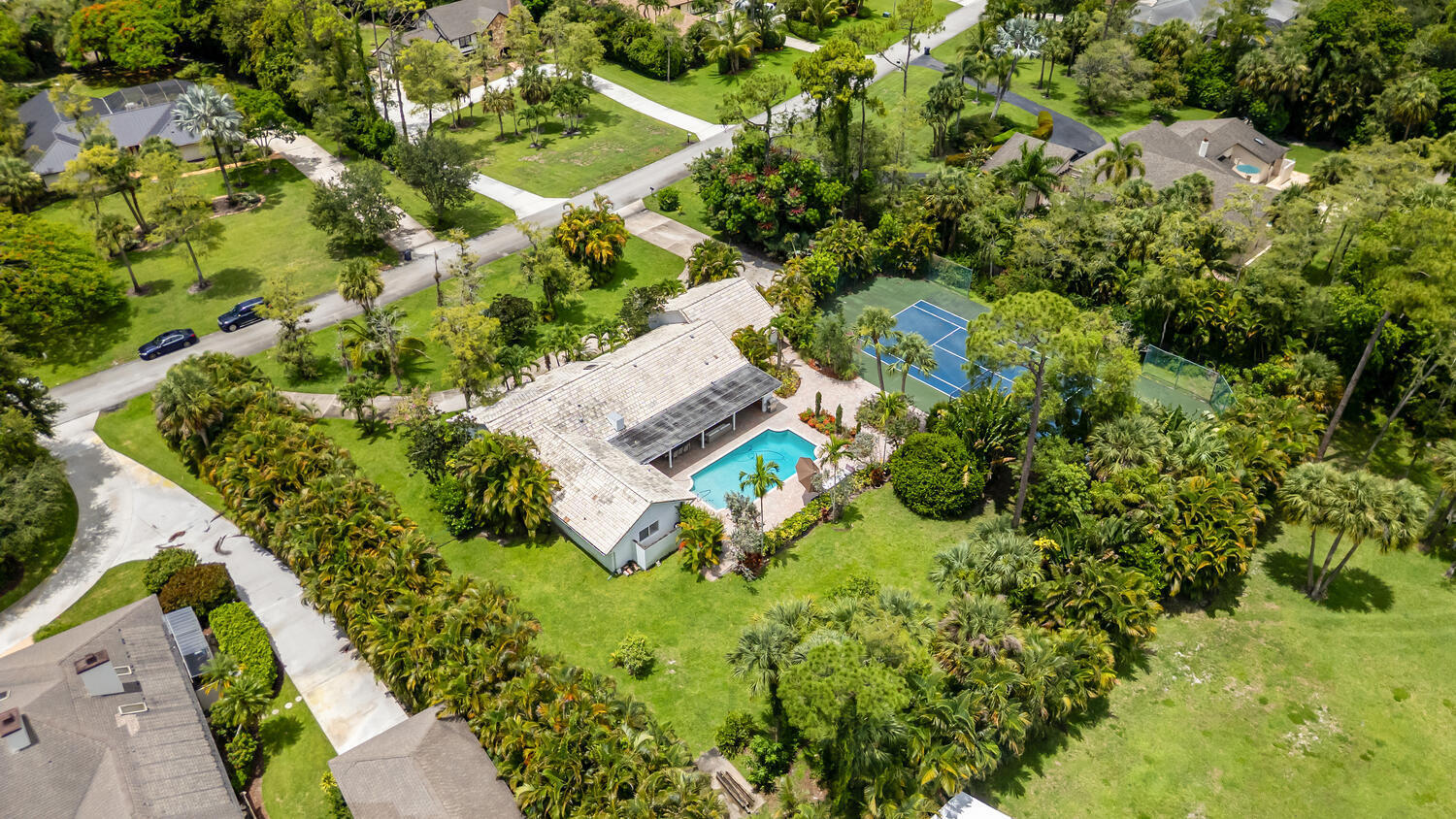 12327 Quercus Lane Wellington, FL 33414 - Photo 33 of 34 an aerial view of residential house with outdoor space and trees all around