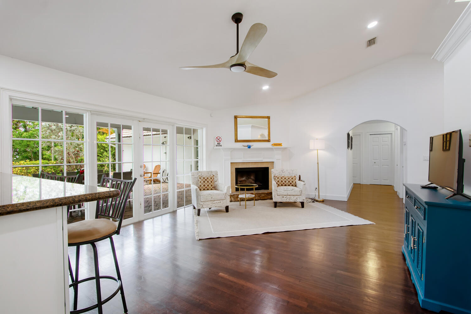 12327 Quercus Lane Wellington, FL 33414 - Photo 6 of 34 a living room with furniture a fireplace and a large window
