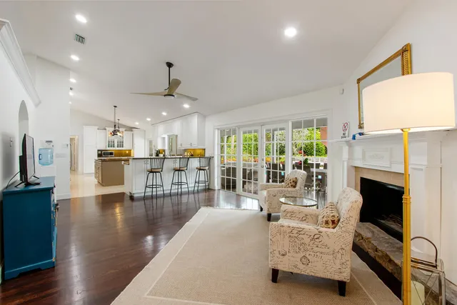 a living room with furniture fireplace and flat screen tv