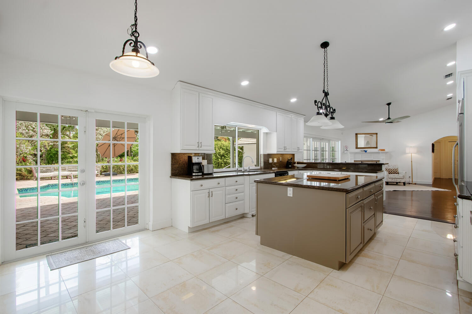 12327 Quercus Lane Wellington, FL 33414 - Photo 10 of 34 a kitchen with stainless steel appliances granite countertop a stove and a sink