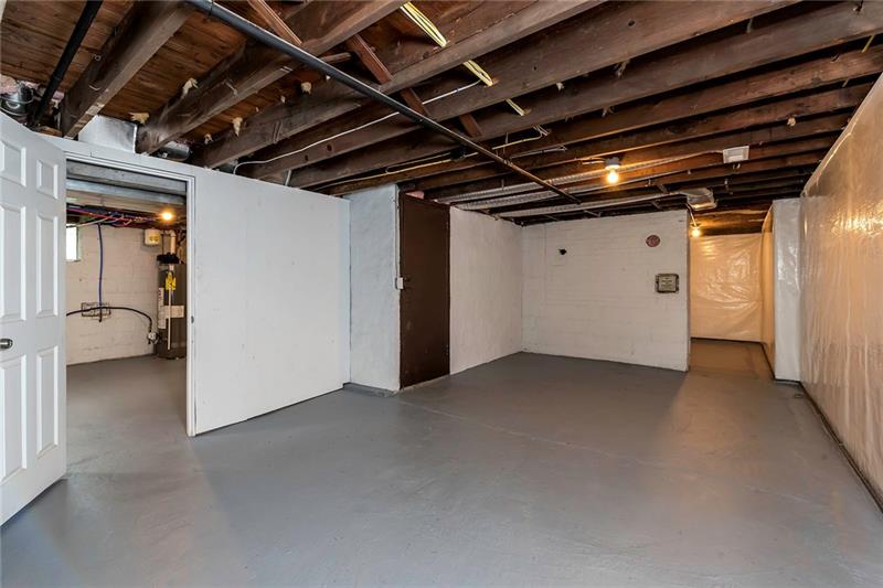 3325 Comanche Road Pittsburgh, PA 15241 - Photo 22 of 25 Lower Level with Potential for a Home Gym, Playspace or Abundant Storage. Owners Installed a Sump Pump, Floor Drainage, and Wall System to Ensure a Dry Basement. Warranty with Basement Waterproofing Transfers to the New Owners.