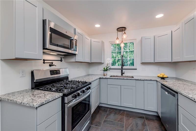 3325 Comanche Road Pittsburgh, PA 15241 - Photo 10 of 25 All New Kitchen with Grey Cabinetry, All Stainless Appliances with 5-Burner Gas Stove, New Recessed Lighting, Pit Filler, Wonderful Hammered Copper Sink and Italian Stone Tile Flooring.