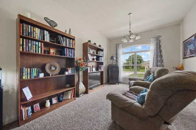 a living room with furniture and a book shelf