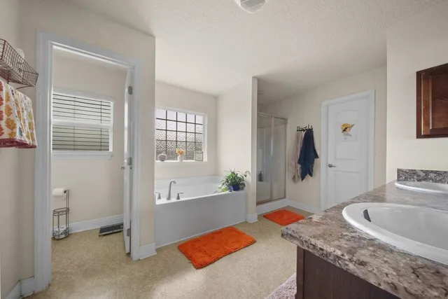 a kitchen with granite countertop sink and natural light