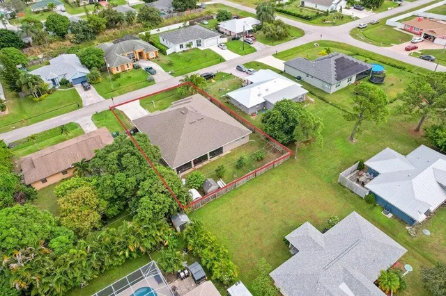 an aerial view of residential houses with outdoor space and street view