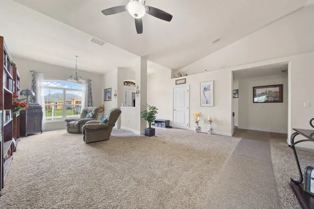 a view of a livingroom with furniture and a ceiling fan