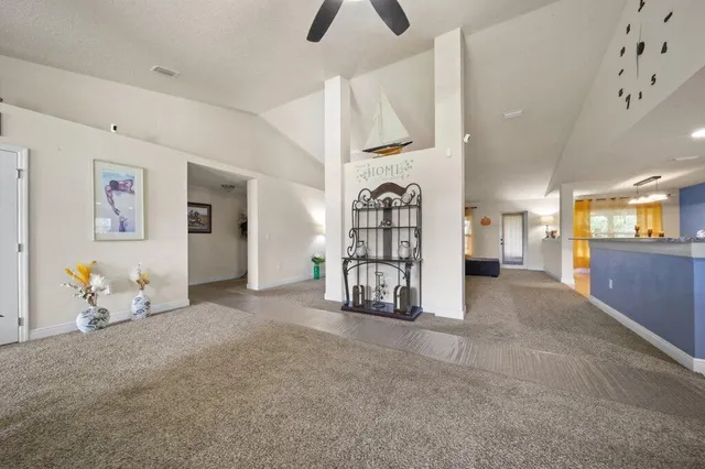 a view of an empty room with closet and windows