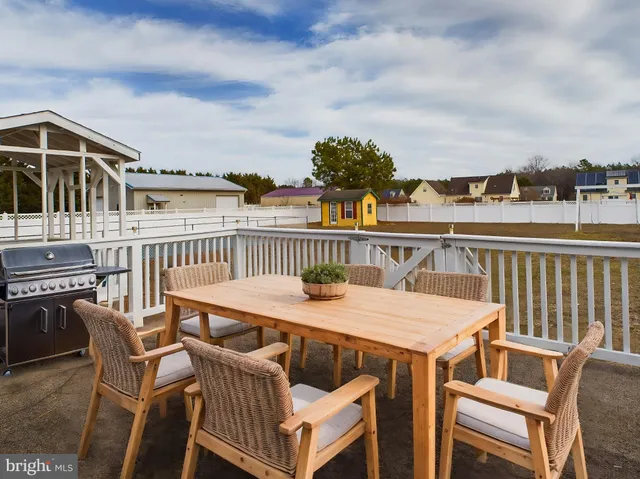 a terrace of a house with wooden floor outdoor seating