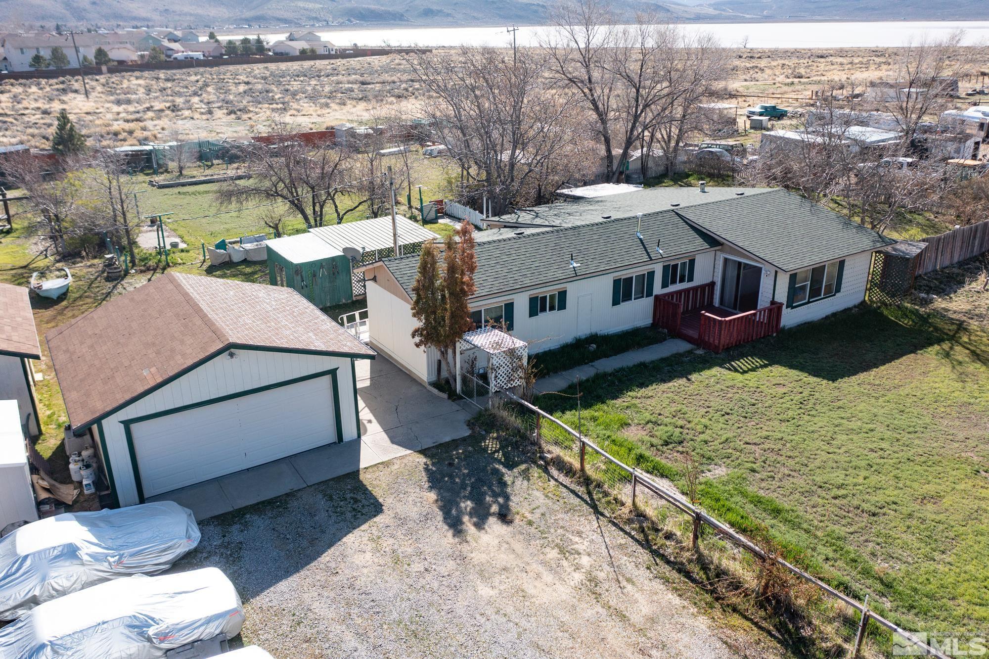 a aerial view of a house with yard porch and sitting area