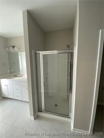 a spacious bathroom with a tub sink and mirror