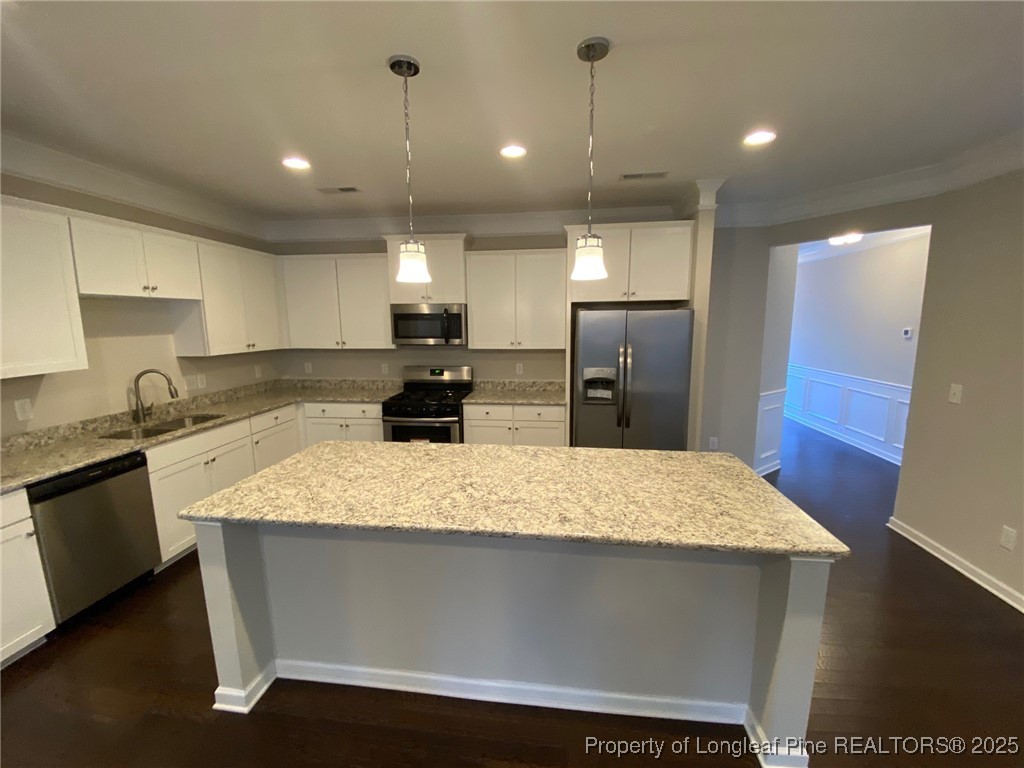 1206 Wingstem Place Cary, NC 27607 - Photo 3 of 26 a large kitchen with kitchen island a sink stainless steel appliances and cabinets