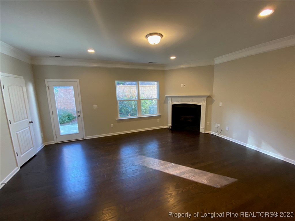 1206 Wingstem Place Cary, NC 27607 - Photo 8 of 26 an empty room with wooden floor and windows