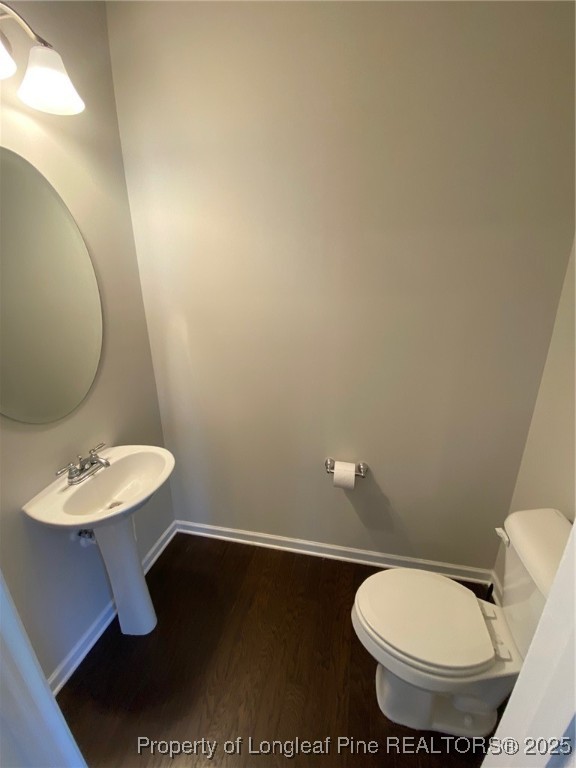 1206 Wingstem Place Cary, NC 27607 - Photo 10 of 26 a bathroom with a toilet sink and mirror