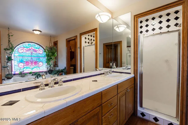 a bathroom with a sink double vanity and a mirror