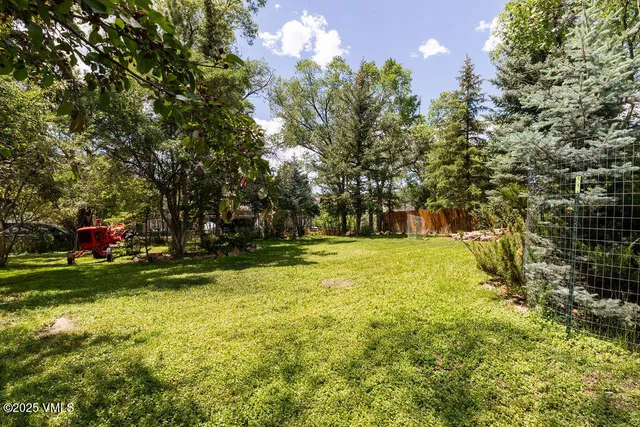 a view of a yard with swimming pool