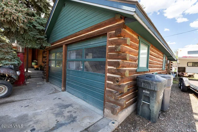 a backyard of a house with barbeque oven and outdoor seating