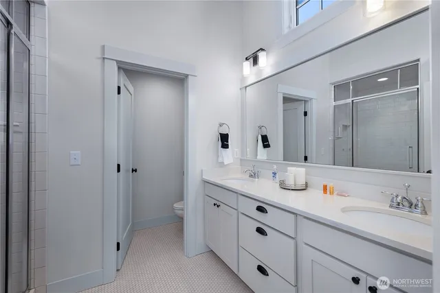 a bedroom with a large bed and wooden floor