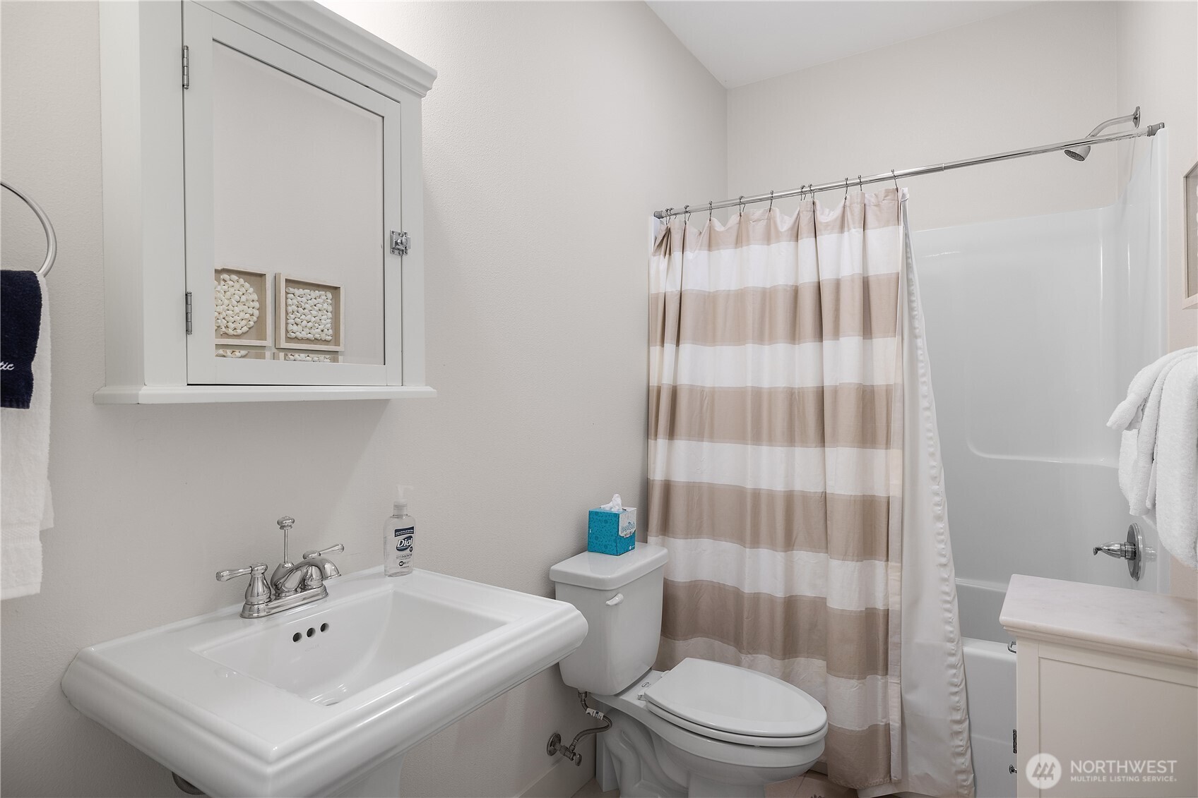 34 Seaside Lane Pacific Beach, WA 98571 - Photo 25 of 33 a bathroom with a sink a toilet and shower curtain
