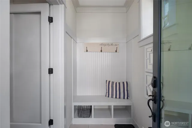 a view of a hallway with chairs and door