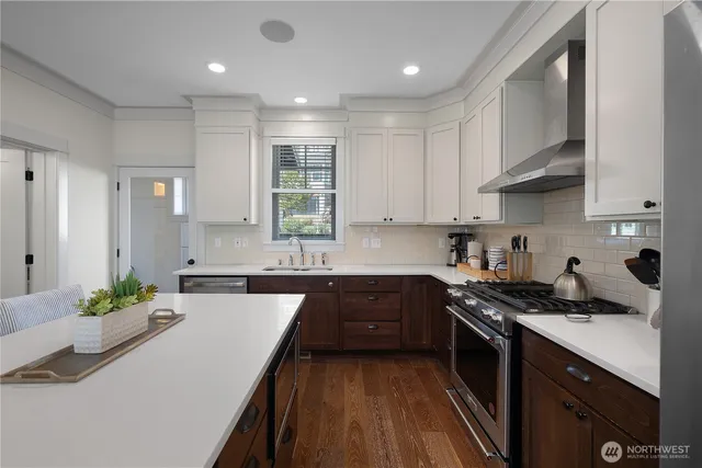 a kitchen with stainless steel appliances granite countertop sink stove and cabinets