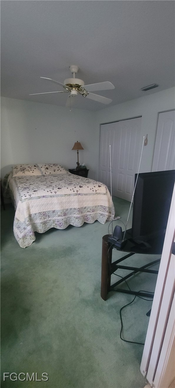 126-128 Tangerine Road Lake Placid, FL 33852 - Photo 19 of 29 a bedroom with a bed and wooden floor